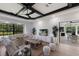 Elegant living room with a fireplace, large windows, and a view of the backyard at 7011 Belmont Ct, Lakewood Ranch, FL 34202
