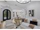 Living room with an ornate entry door, dining area, and comfortable white furnishings at 7011 Belmont Ct, Lakewood Ranch, FL 34202