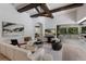 Cozy living room with sectional sofa, modern decor, and view into kitchen at 7011 Belmont Ct, Lakewood Ranch, FL 34202
