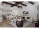 Bright, open living space featuring white finishes, ceiling beams, living room, kitchen, and counter seating at 7011 Belmont Ct, Lakewood Ranch, FL 34202