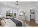A beautifully furnished main bedroom featuring a cozy seating area, elegant decor, and bright natural light at 7011 Belmont Ct, Lakewood Ranch, FL 34202