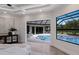 Bright main bedroom featuring hardwood floors and view of the pool and patio at 7011 Belmont Ct, Lakewood Ranch, FL 34202