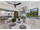 Outdoor kitchen with stainless steel appliances, a dining table, and a view of the backyard at 7011 Belmont Ct, Lakewood Ranch, FL 34202