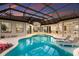 Stunning screened-in pool with a spa and elegant lounge chairs, perfect for relaxation and entertaining at 7011 Belmont Ct, Lakewood Ranch, FL 34202