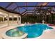Sparkling pool and jacuzzi with lush tropical landscaping at 7011 Belmont Ct, Lakewood Ranch, FL 34202