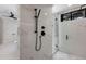 Spacious shower featuring marble tiling, black fixtures, and seamless glass doors at 7011 Belmont Ct, Lakewood Ranch, FL 34202
