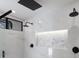 Sleek shower featuring dual shower heads, decorative tiling, and a built-in shower niche at 7011 Belmont Ct, Lakewood Ranch, FL 34202