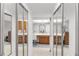 Bright bathroom including white vanities and a large central mirror and sliding mirrored doors at 7218 Cloister Dr # 7218, Sarasota, FL 34231