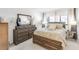 Primary bedroom featuring ensuite bathroom and a dresser with large mirror, plus bedside tables at 7218 Cloister Dr # 7218, Sarasota, FL 34231