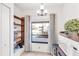 Bright eating nook with exterior view and storage shelves and lighting fixture at 7218 Cloister Dr # 7218, Sarasota, FL 34231