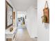 Bright hallway with tile flooring, featuring stylish decor and a glimpse into the spacious living area at 7218 Cloister Dr # 7218, Sarasota, FL 34231