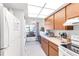 Bright kitchen includes stainless appliances and lighting, in-unit washer/dryer hookups, and exterior window at 7218 Cloister Dr # 7218, Sarasota, FL 34231