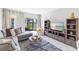 Bright living room with a sliding glass door to the outdoor area, stylish decor, and plush seating at 7218 Cloister Dr # 7218, Sarasota, FL 34231