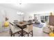 Open-concept living and dining area with contemporary furnishings and abundant natural light at 7218 Cloister Dr # 7218, Sarasota, FL 34231