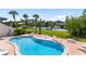Community pool surrounded by lush landscaping and seating, perfect for leisure at 7218 Cloister Dr # 7218, Sarasota, FL 34231