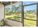 Relaxing screened porch with view overlooking a scenic lawn and waterway at 7218 Cloister Dr # 7218, Sarasota, FL 34231