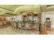 Upscale bar with comfortable seating, wooden bar with stone countertop, and liquor display shelves at 7528 Ascot Ct, Bradenton, FL 34201