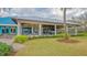 Attractive building with a blue roof and large patio area, surrounded by lush greenery at 7528 Ascot Ct, Bradenton, FL 34201