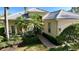 Inviting single-story home featuring a tile roof, walkway, mature landscaping, and manicured lawn at 7528 Ascot Ct, Bradenton, FL 34201