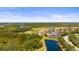 Stunning aerial view showcasing the neighborhood, golf course, and lake views at 7607 Grand Estuary Trl # 302, Bradenton, FL 34212