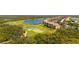 Scenic aerial view of the property with golf course, ponds, and surrounding trees at 7607 Grand Estuary Trl # 302, Bradenton, FL 34212