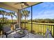 Inviting outdoor screened lanai with chairs and golf course views at 7607 Grand Estuary Trl # 302, Bradenton, FL 34212
