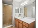 Bathroom featuring glass shower door, modern vanity and lighting at 7607 Grand Estuary Trl # 302, Bradenton, FL 34212
