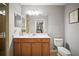 Bathroom features single sink vanity, toilet, framed mirror and a glass door shower at 7607 Grand Estuary Trl # 302, Bradenton, FL 34212
