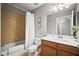 Cozy bathroom featuring a shower-tub combo, wood vanity, and neutral tile flooring at 7607 Grand Estuary Trl # 302, Bradenton, FL 34212