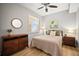 Cozy bedroom with wood floors, dresser, and ceiling fan at 7607 Grand Estuary Trl # 302, Bradenton, FL 34212