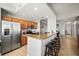 Kitchen with a large stainless steel refrigerator, granite countertops, bar seating, and stainless appliances at 7607 Grand Estuary Trl # 302, Bradenton, FL 34212