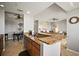 Well-appointed kitchen with granite countertops, tile flooring, and an eat-in bar that opens into the dining area at 7607 Grand Estuary Trl # 302, Bradenton, FL 34212