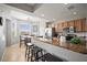 Kitchen with stainless steel appliances, granite countertops, breakfast bar with seating and adjacent eat-in nook at 7607 Grand Estuary Trl # 302, Bradenton, FL 34212