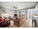 Comfortable living area with neutral walls, tile flooring, a ceiling fan, and sliding glass doors to the balcony at 7607 Grand Estuary Trl # 302, Bradenton, FL 34212