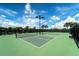 Well-maintained tennis courts on a sunny day with a bright blue sky at 7607 Grand Estuary Trl # 302, Bradenton, FL 34212