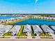 An aerial view showcases waterfront homes, modern architecture, lush landscaping, and a serene community setting at 8107 Slipway Dr, Sarasota, FL 34240