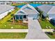 Aerial view of a lovely home with a paver driveway, tropical landscaping, and a serene lake backdrop at 8107 Slipway Dr, Sarasota, FL 34240
