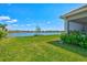 This lush backyard overlooks a tranquil lake, boasting manicured lawns and mature shrubs that enhance its appeal at 8107 Slipway Dr, Sarasota, FL 34240