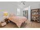 Cozy bedroom with wood floors, ceiling fan, walk-in closet, and shelving at 8107 Slipway Dr, Sarasota, FL 34240