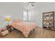 Cozy bedroom with wood floors, ceiling fan, closet, and shelving at 8107 Slipway Dr, Sarasota, FL 34240
