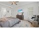 Bright bedroom featuring a dresser with TV and a cozy chair with window view at 8107 Slipway Dr, Sarasota, FL 34240