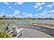 Waterfront patio with a stone wall, lounge chairs, and tranquil views of the water at 8107 Slipway Dr, Sarasota, FL 34240