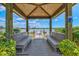 Picturesque gazebo with seating, offering a tranquil spot to enjoy scenic lake views and access to the community dock at 8107 Slipway Dr, Sarasota, FL 34240