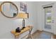 Bright entryway featuring a wood console table with decor, a round mirror, and a view of the outdoors at 8107 Slipway Dr, Sarasota, FL 34240