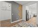 Modern home entryway featuring wood floors, decorative wall accents, and an open floor plan to the kitchen at 8107 Slipway Dr, Sarasota, FL 34240