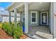 Cozy front porch with stylish chairs, lush plants, and a welcoming entrance with blue door at 8107 Slipway Dr, Sarasota, FL 34240