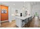 Modern kitchen featuring sleek white cabinets, a large island with seating, and pendant lighting at 8107 Slipway Dr, Sarasota, FL 34240