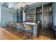 Modern bar with ample seating, granite countertop, and stainless steel appliances at 8107 Slipway Dr, Sarasota, FL 34240