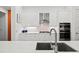 Modern white kitchen with stainless steel appliances and stylish backsplash at 8107 Slipway Dr, Sarasota, FL 34240