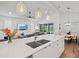 Kitchen and living room with large island, pendant lights, and open-concept design at 8107 Slipway Dr, Sarasota, FL 34240
